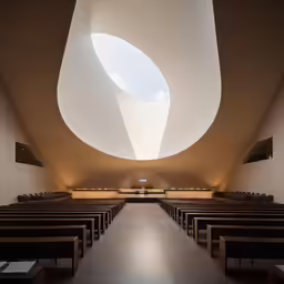 a church filled with pews and skylight