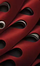 closeup of a red cloth material with holes on the bottom