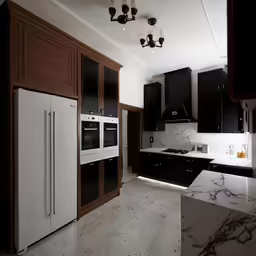 a white and black kitchen with marble counter tops