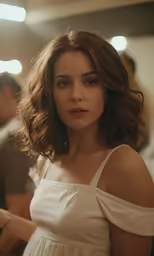 a woman in a white dress posing for the camera