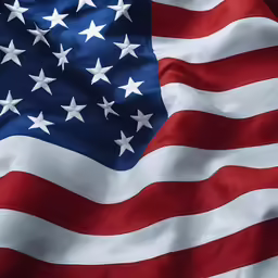 an american flag with stars blowing in the wind