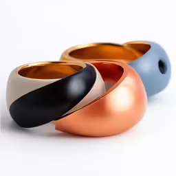 three rings that have been colored gold, white, and blue