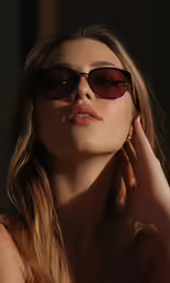 woman in a bra showing her face with dark light on