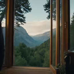 a bedroom with a mountain view out the window