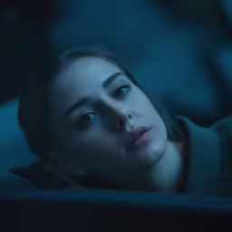 a woman looking into the distance with blue eyes