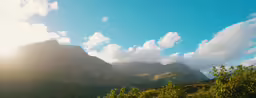there is a large mountain with a blue sky above