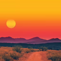 a sun setting over the hills in the distance