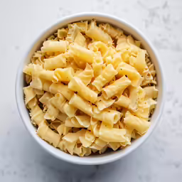 a bowl of pasta with some parmesan cheese