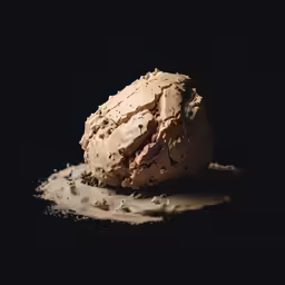 an ice cream in a glass bottle next to dark background