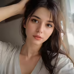 a young woman wearing a white top is looking away