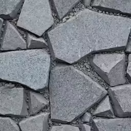 a pile of large rocks sitting on top of a sidewalk