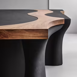 two black tables, each with a different wood top