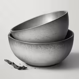 a metal bowl with a spoon on top of it