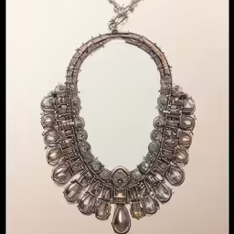 the necklace is adorned with stones and silver beads
