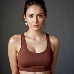 a woman is posing for the camera in her bra top