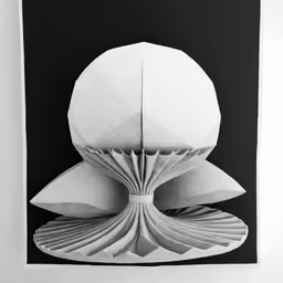 a black and white photo of a paper sculpture