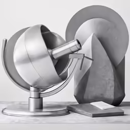 an abstract sculpture sits on a marble base