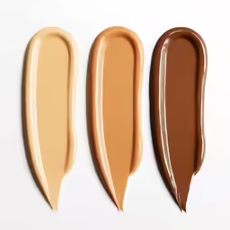 three shades of lip cream in four shades of different shade, on a white surface