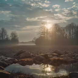 the sun is shining through a misty, blue sky