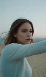 the girl is posing with her hair in the wind