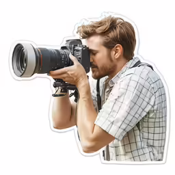 a man holding up his camera while looking at it