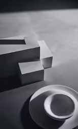 white plate sits beside some empty plates