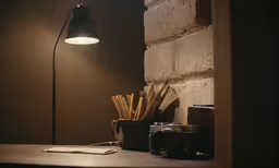 some books, a camera and a lamp on a table