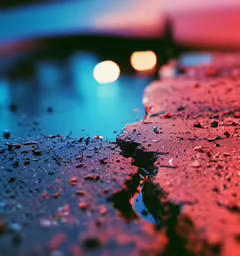 a blurry photograph of wet concrete at dusk