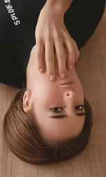 a woman holding the wrist of another women head