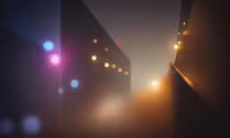 a blurred photograph of an urban street at night