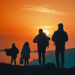 a group of people standing on top of a hill