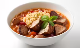 a white bowl containing meat, rice and tomatoes