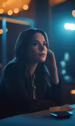 the beautiful woman looks into her right hand on her chin