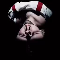 the young person wearing red and white is upside down