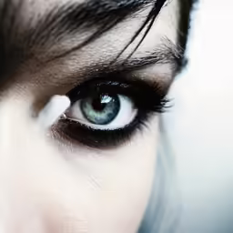 a woman has long eyelashes and black lashes