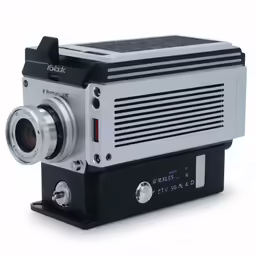an old camera sitting on top of a white table
