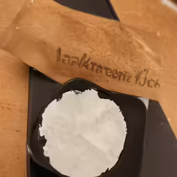 a pastry tin with powdered sugar beside it