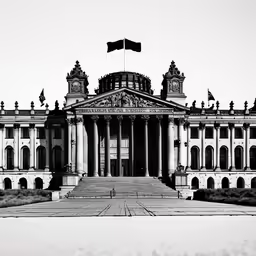 a very large building with many columns and flags