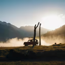 a red truck traveling down a lush green hillside