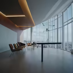 the room has high ceilings, a table with four chairs and chairs around it