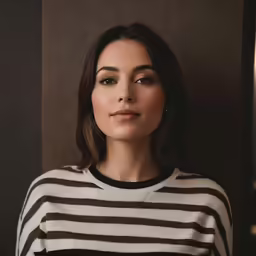 the young woman is posing for the camera