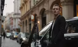 a man standing in the doorway of a car