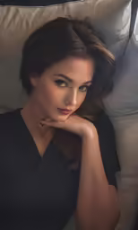 the beautiful lady poses for a portrait while laying on a chair