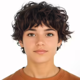 young boy with curly hair looking to the side