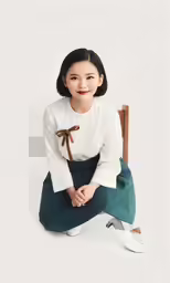 a young woman is smiling while sitting on the ground