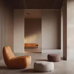 an empty room with a couch and ottomans