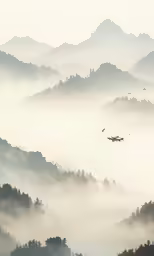 a mountain covered in fog with three airplanes flying in the distance