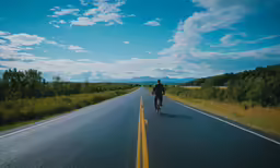 a man on a bicycle rides down the street