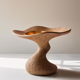 a wooden vase with oranges inside it