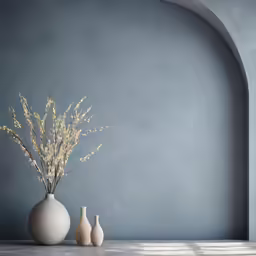a white vase holding some pretty flowers on a table